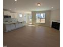 Open concept living room showcasing fireplace, hardwood floors, and lots of light at 8 Steppe Way, Garner, NC 27529