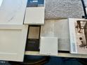 Selection of interior design materials and finishes, including flooring, countertop, and cabinet samples at 108 Commons Circle # 228, Clayton, NC 27520