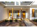 Charming front porch with rocking chairs and wooden posts at 151 Ottawa Dr, Louisburg, NC 27549