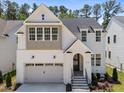 Charming two-story home with a white brick facade, two-car garage, and a welcoming front entrance at 1721 Burnette Garden Path, Raleigh, NC 27612