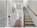 Welcoming entryway with staircase, neutral decor, and wood floors create a bright and inviting space at 211 Pond View Ct # 5, Fuquay Varina, NC 27526
