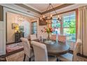 This dining room has a round wood table, six chairs, and modern chandelier lighting at 3177 Armeria Dr, Apex, NC 27502