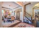 Elegant dining room features stylish chandelier, round table with six chairs, and an arched mirror at 3177 Armeria Dr, Apex, NC 27502