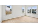 Bedroom with neutral paint, wood floors, and natural light through windows at 3301 Oakfields Rd # 2, New Hill, NC 27562