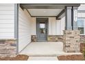 Charming front entrance with gray door, stone accents, and decorative column at 3301 Oakfields Rd # 2, New Hill, NC 27562