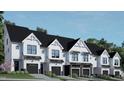 Modern townhome community with sleek, white exteriors and black garage doors at 4043 Elk Creek Ln # 15, Raleigh, NC 27612