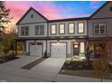 Attractive townhome displaying its front facade during sunset, showcasing architectural details and curb appeal at 507 Excelsior Ct, Rolesville, NC 27587