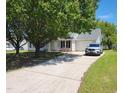 Inviting home with a lush lawn, long driveway and attached garage at 113 S Friars Chase Ln, Fuquay Varina, NC 27526