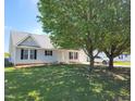 Charming home with mature trees in the front yard at 113 S Friars Chase Ln, Fuquay Varina, NC 27526