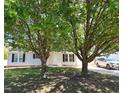 Beautiful single-story home with mature trees in the front yard at 113 S Friars Chase Ln, Fuquay Varina, NC 27526