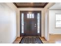 Welcoming foyer with a modern front door, striking rug, and freshly painted walls at 2804 Edgewood Ave, Burlington, NC 27215
