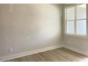 Bright bedroom featuring new, light wood flooring and large windows allowing natural light at 478 Traditions Grande Blvd # 32, Wake Forest, NC 27587