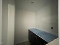 Functional mudroom with dark cabinets and countertop, offering practical storage solutions at 478 Traditions Grande Blvd # 32, Wake Forest, NC 27587