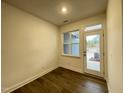 Spacious bonus room with hardwood floors, natural light, and back patio access at 482 Traditions Grande Blvd # 30, Wake Forest, NC 27587