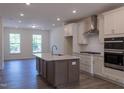 Open-concept kitchen boasts a large island, stainless appliances, and adjacent open dining space at 482 Traditions Grande Blvd # 30, Wake Forest, NC 27587