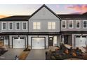 New two-story townhome at sunset with a two car garage and light gray and white paint at 703 Jamescroft Way, Rolesville, NC 27587