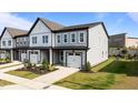 New two-story townhouse featuring a one car garage, gray siding, and manicured landscaping at 709 Jamescroft Way, Rolesville, NC 27587