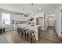 Bright, open kitchen with a large island, white cabinets, and modern pendant lighting at 709 Jamescroft Way, Rolesville, NC 27587