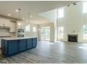 Open-concept kitchen with stainless steel appliances and a large center island at 8305 Cannon Grove Dr, Willow Springs, NC 27592
