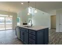 Stylish kitchen island with a sink, ample storage space, and modern fixtures at 8305 Cannon Grove Dr, Willow Springs, NC 27592