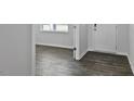 Home entryway features wood-look floors, a white front door, and views of the living area at 98 Ethel Ln, Angier, NC 27501