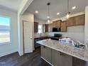 Spacious kitchen boasts granite counters and stainless steel appliances at 155 Waterwheel Dr, Selma, NC 27576
