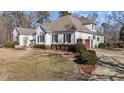 White house with brown roof, landscaping, and a two-car garage at 319 Fox Hollow Dr, Clayton, NC 27527