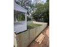 Fenced in backyard and a view of the house with a white porch at 3302.5 Hall Pl, Raleigh, NC 27607