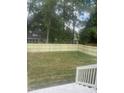 Large backyard is enclosed with a light wooden fence at 3302.5 Hall Pl, Raleigh, NC 27607