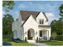 Charming two-story home featuring a blend of white siding and brick with a cozy front porch and landscaped yard at 3302.5 Hall Pl, Raleigh, NC 27607