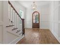 Beautiful foyer with hardwood floors, white paneled walls, and a staircase leading to the upper level at 3302.5 Hall Pl, Raleigh, NC 27607