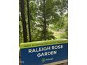 Raleigh Rose Garden sign in a scenic park with trees at 3302.5 Hall Pl, Raleigh, NC 27607