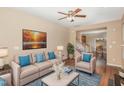 Inviting living room with hardwood floors, a comfortable couch, and natural light at 3417 Cardinal Lake Dr, Durham, NC 27704