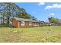 Charming single-story brick home with blue shutters, a covered porch, and a well-maintained lawn at 2169 Northcrest Dr, Elon, NC 27244