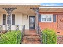 Charming front porch with brick steps and decorative iron railings at 229 Davis Mill Rd, Selma, NC 27576