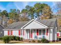 Gray house with red shutters, a covered porch, and landscaping at 512 Drexel Rd, Rocky Mount, NC 27803