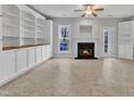 Bright living room with built-in bookshelves, fireplace and tile flooring at 9009 Grassington Way, Raleigh, NC 27615