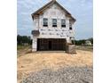 Under construction two-story home with a large garage, showcasing future charm and potential at 1011 Shovelhead Dr # 6, Durham, NC 27703