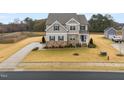 An aerial view showcasing the home's location near a serene pond and expansive lawn at 254 Dungannon, Clayton, NC 27520