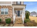 A welcoming front porch with stone steps and white railing, complementing the home's exterior at 254 Dungannon, Clayton, NC 27520