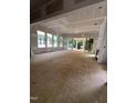 Spacious living room with large windows offering abundant natural light and a sliding glass door to a deck at 3302 Hall Pl, Raleigh, NC 27607