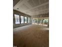 Unfinished living room features large windows, trimwork, and sliding glass door access to back deck at 3302 Hall Pl, Raleigh, NC 27607