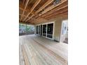 Expansive new deck area with sliding glass doors that seamlessly connects indoor and outdoor living spaces at 3302 Hall Pl, Raleigh, NC 27607