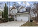 Two-story home with a two-car garage, driveway, well-maintained landscaping, and complementary green siding at 4324 Brighton Ridge Dr, Apex, NC 27539