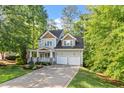 Charming two-story home featuring a welcoming front porch, two-car garage, and lush landscaping at 4324 Brighton Ridge Dr, Apex, NC 27539