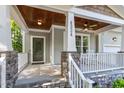 Inviting front porch featuring stone accents, comfortable seating, and a stylish ceiling fan at 4324 Brighton Ridge Dr, Apex, NC 27539