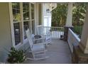 Relaxing front porch with white rocking chairs and classic outdoor furniture at 4324 Brighton Ridge Dr, Apex, NC 27539