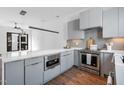 Modern kitchen features stainless steel appliances, gray cabinetry, and a breakfast bar at 512 Gordon Street # 602, Durham, NC 27701
