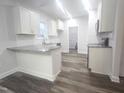 Modern kitchen with granite countertops, white cabinets, and an island at 52 Roll Tide Ct, Angier, NC 27501