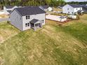 Aerial view of a backyard featuring a screened-in porch and spacious lawn at 59 Davinhall Dr, Fuquay Varina, NC 27526